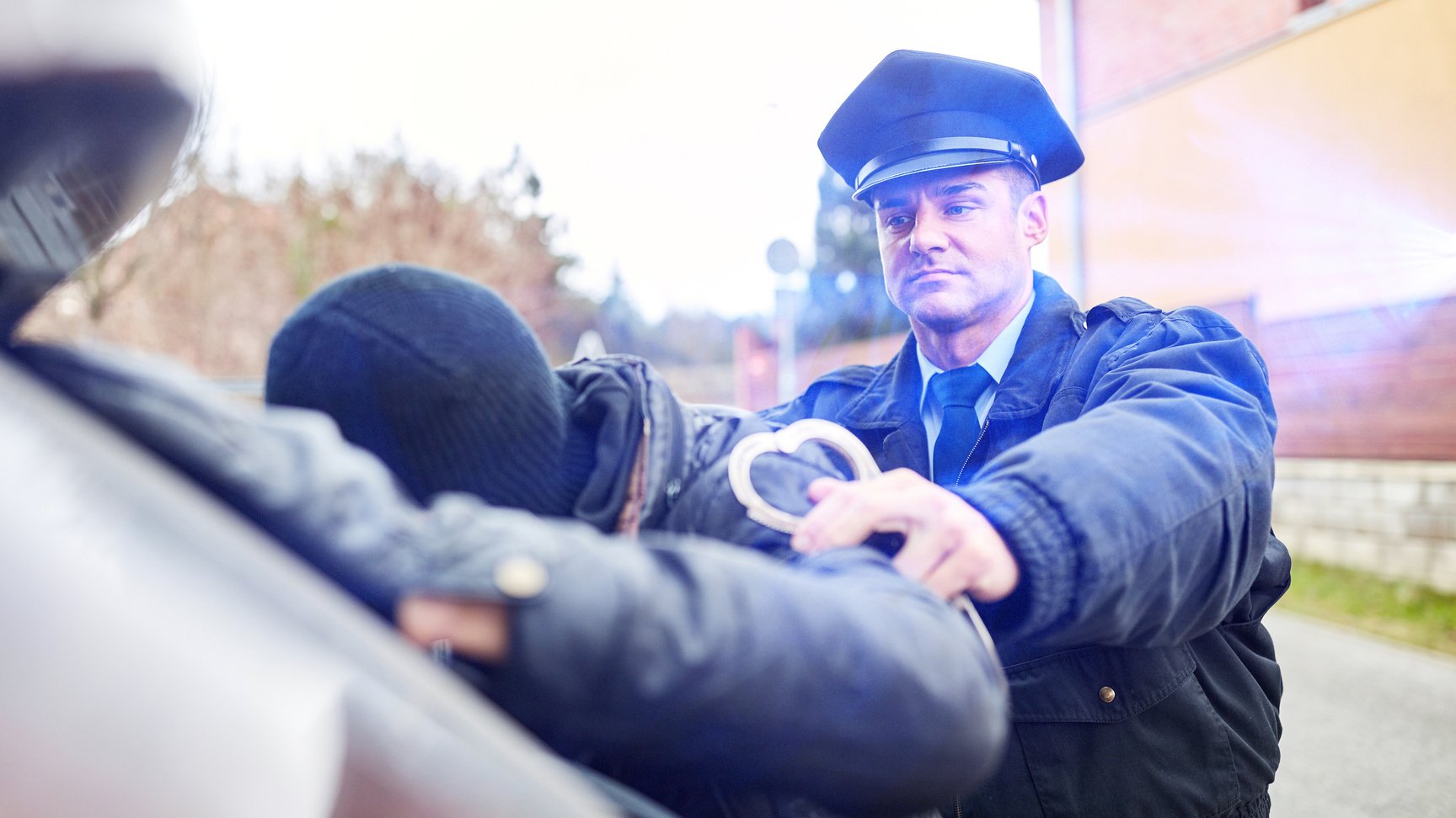 Police with Blue Light on Arrest in Action